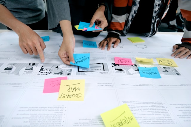 An image of people visualizing a Customer Journey Map